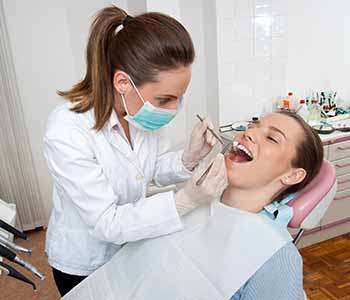 Image of a Dentist checking Patient mouth