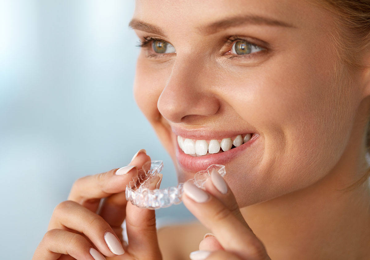 The Invisalign clear teeth-straightening system can restore a more natural bite pattern at Hebron Smiles in Carrollton
